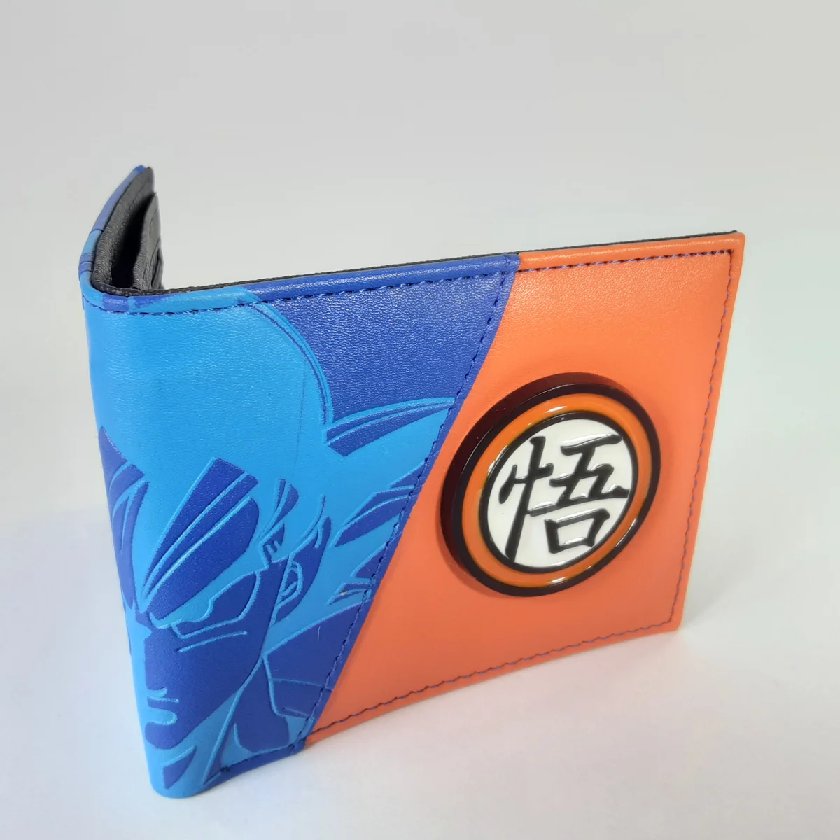Billetera Dragon Ball Gokú naranja y azul con kanji de sabiduría